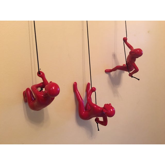 This listing is for a 3 pc set wall-mount sculpture of a man climbing a rope for distinctive décor accent. Crafted from...