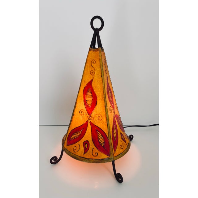 This one of a kind, Moroccan leather table lamp, is handcrafted from goat or camel skin, stretched over a firm wrought...