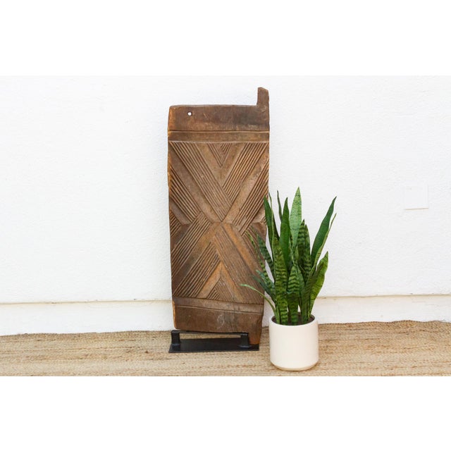 Hand-carved from a single plank of hardwood, this door presents a clean, confident take on Mali's Dogon and Bamana...