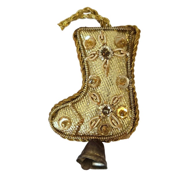 Striking padded mini hanging ornaments in gold tones elaborately embroidered with metal threads using traditional zardozi...