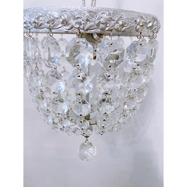 This is a basket chandelier with decorative silver rim with 30% leaded A-chain crystals. It has 1 Edison base socket that...