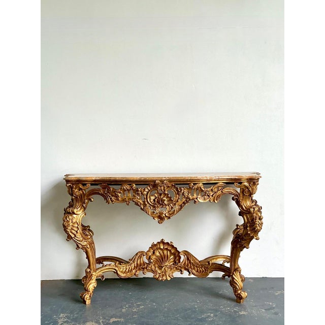 This grand antique Rococo console table is a breathtaking masterpiece of European artistry, epitomizing the drama and...