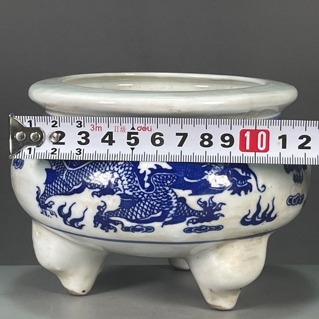 This is an impressive vintage porcelain tripod censer , decorated in the classic blue and white palette. The censer...