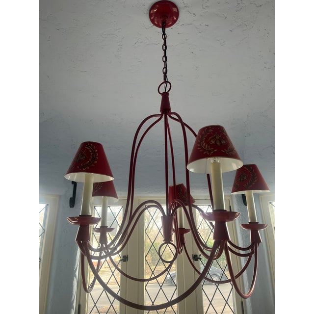 Add a bold pop of French-inspired charm to your space with this striking six-light red wrought iron chandelier. This...