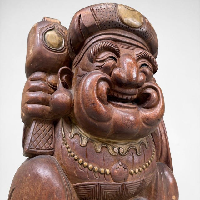 A large and expressive Japanese wooden statue of Daikoku, one of the Seven Lucky Gods, symbolising prosperity, wealth,...