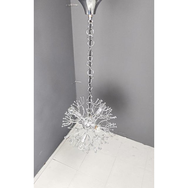 Mid century chrome sputnik chandelier by Gaetano Sciolari. The lamp emits a spectacular light. Light patina visible....