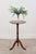 This 19th-century side table features a yew tabletop and a walnut ring-turned pedestal base with tripod legs ending in...