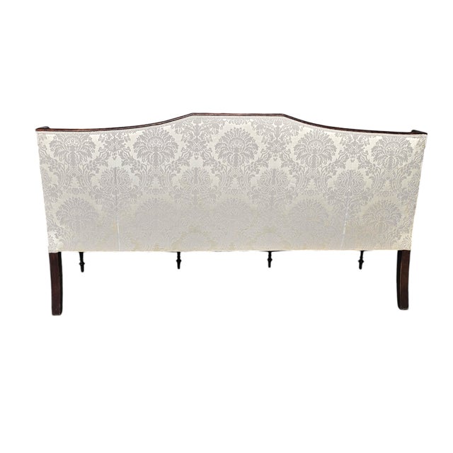 Federal style mahogany settee, early 20th century, executed in the Hepplewhite tradition with a refined shield-form back...