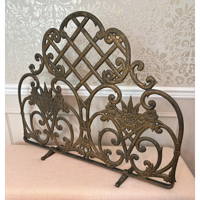 An ornate 1990s UniFlame cast aluminum fireplace screen with sweeping scrollwork, sculpted flowers and leaves, and an open...