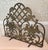 An ornate 1990s UniFlame cast aluminum fireplace screen with sweeping scrollwork, sculpted flowers and leaves, and an open...