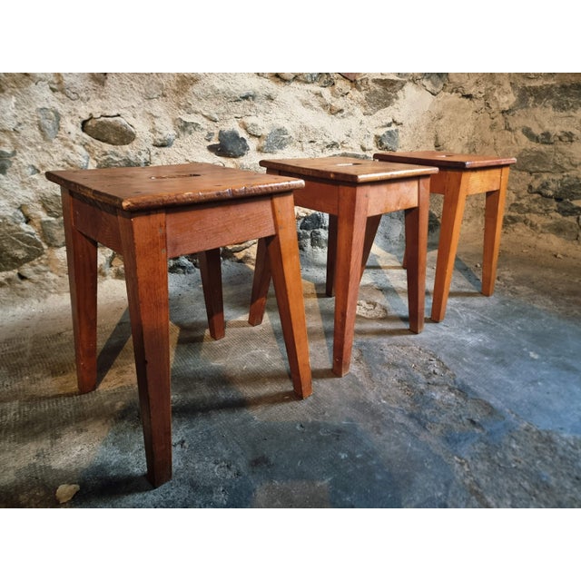 Set of three vintage wooden stools originating from France and dating to the 1950s. These stools are constructed with...