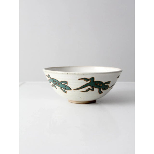 A vintage studio pottery bowl, 1999, signed “Eric 99.” this large ceramic bowl features a softly speckled white glaze with...