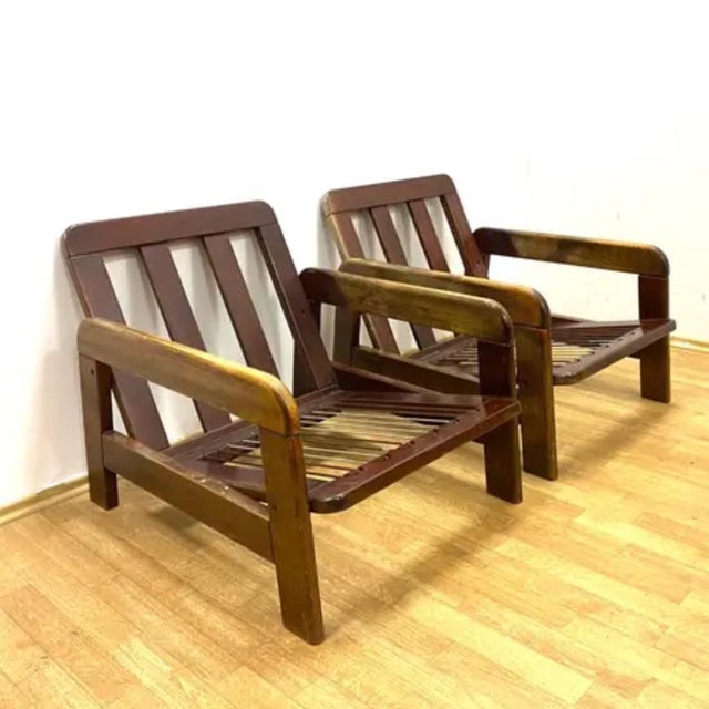 A pair of stylish retro armchairs from the second half of the 20th century, featuring a solid wooden frame, removable...