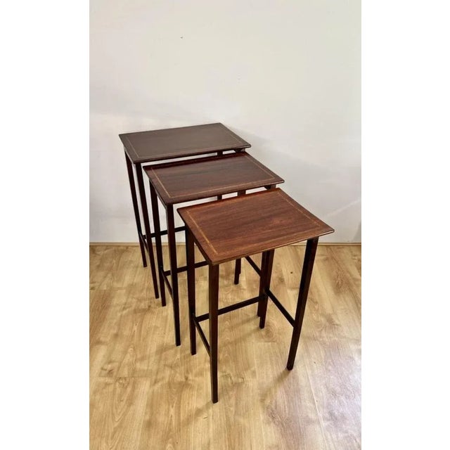 Nest of three antique Edwardian quality mahogany inlaid tables having a quality mahogany rectangular shaped top with...