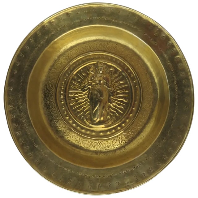 Early brass alms dish bowl with the subject depicted in the centre of this dish is the Virgin Mary. As the mother of Jesus...