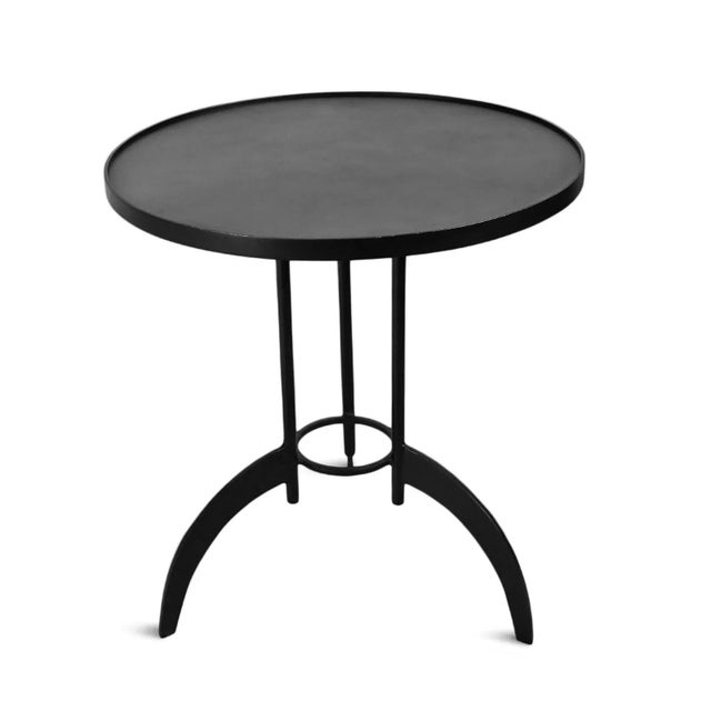 Industrial modern style round iron side table. Antique black finish with three legs. Each may vary in exact distress and...