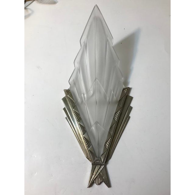 Beautiful pair of French Art Deco wall sconces signed by the French artist “Degue” in clear frosted glass shades with...