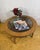 A stylish and elegant mid century modern round coffee table dating from the 1960s–1970s, offering timeless design and...