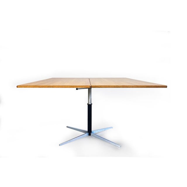 This is an adjustable dining and coffee table, model WR 194, designed by J.M. Thomas in 1959 for the German company...