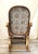 This vintage 1970s Victorian-Revival bentwood rocking chair features an ornate, sculptural triple-scroll frame in a warm...