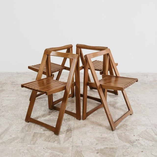 Iconic set of four folding chairs model "Trieste," designed by Aldo Jacober for Alberto Bazzani in the 1960s. Made of...
