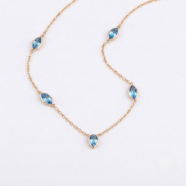 Bring a touch of serene sophistication to your collection with this beautiful station necklace. Designed for both...