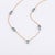 Bring a touch of serene sophistication to your collection with this beautiful station necklace. Designed for both...