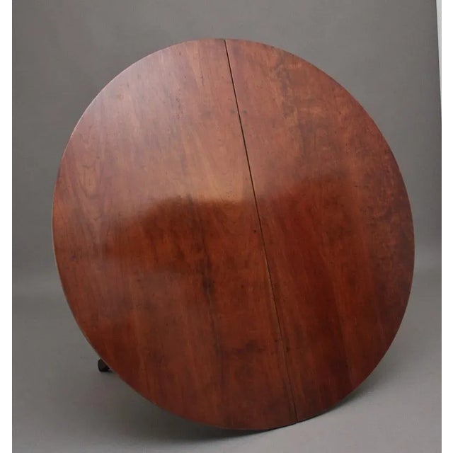 A solid cherry wood extending table with two leaves / extensions in the country French style, the table has a circular...