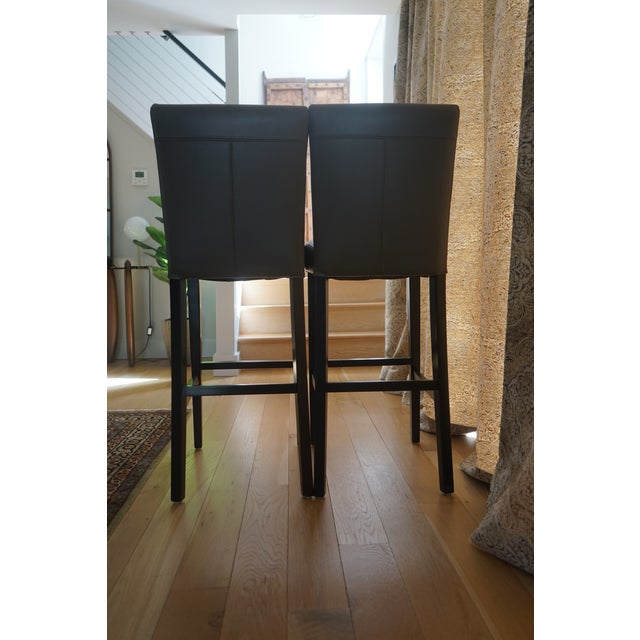 Inspired by classic Parsons design, the Lowe leather stools feature soft, pebble-textured leather in a smoky gray tone....