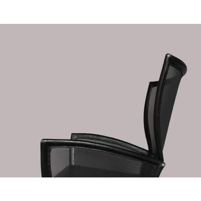 This vintage lounge chair was made in Italy in the 1970s. It is made from aluminum with leather upholstery. This piece is...