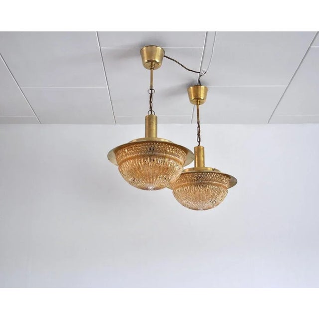 A pair of stunning glass and brass chandeliers by danish vitrika in collaboration with swedish glass manufactory fåglavik....