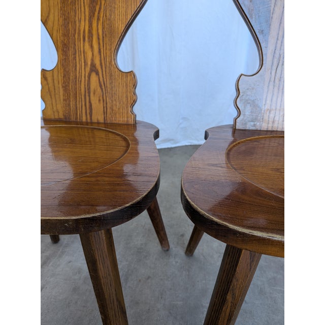 Vintage wooden dining chairs in traditional Tyrolean (Alpine) style. with a shaped backrest and characteristic heart cut-...