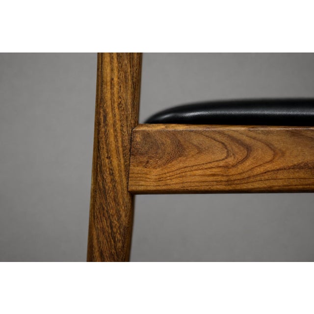 This set of four dining chairs was made in Denmark during the 1960s. The chairs are made of teak wood in a warm shade of...