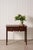18th-century oak lowboy featuring a shaped apron, two drawers with original swan-neck brass handles, and a warm aged...
