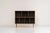 Oak bookcase by Kurt Østervig (Denmark, 1960s). A minimalistic bookcase crated in oak with vertical adjustable shelves and...