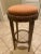 Round bar stool with distressed wooden finish and custom designed fabric. Excellent condition.