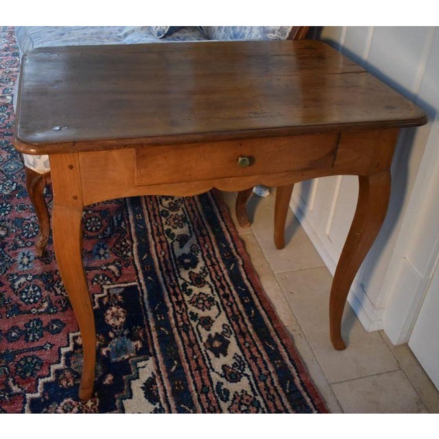 French fruitwood side table in the country Louis XV style with shapely cabriole legs connected with pegs to a case with an...