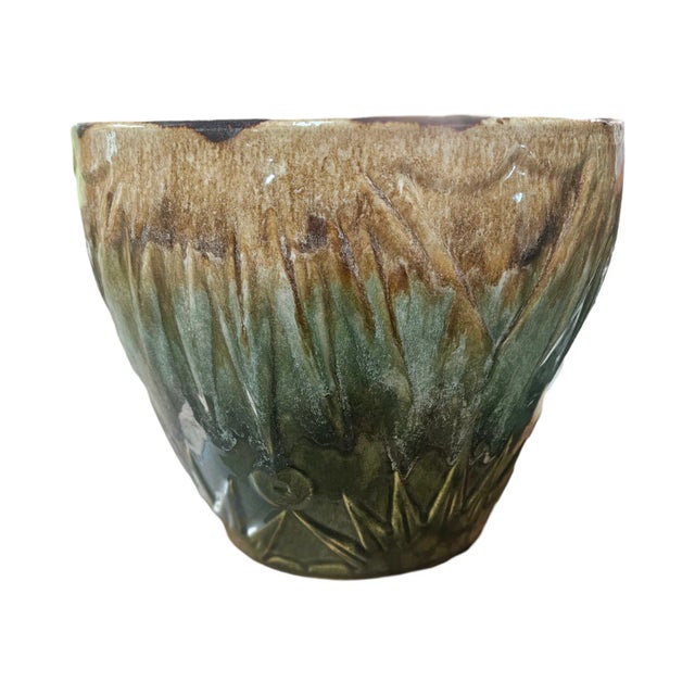 A lovely mid century glazed Roseville pottery planter in the sun and moon pattern.by Robinson Ransbittom. Measures 9...