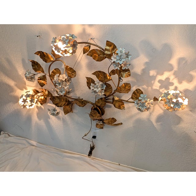 Large Scale Hollywood Regency Wall Lamp, richly detailed with hand forged iron leaves and sculpted hydrangea blossoms. The...
