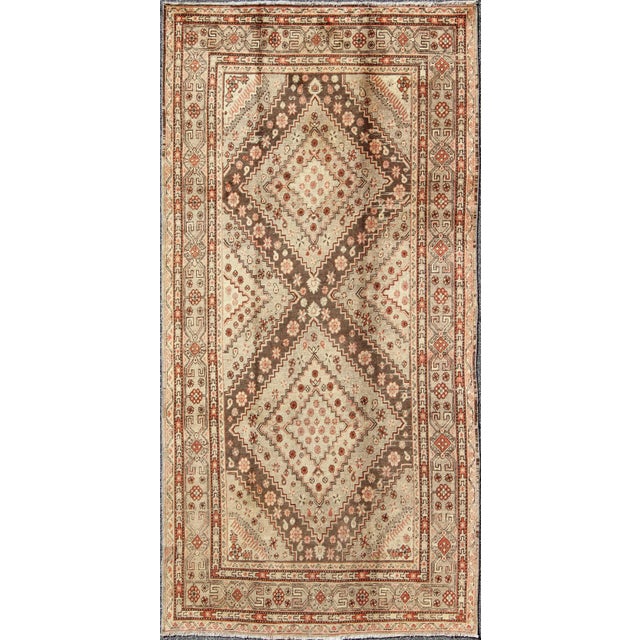 Early 20th Century Antique Khotan Rug With Paired Diamond Medallions in Brown and Earth Tones For Sale