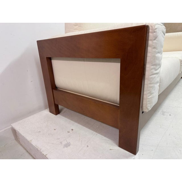 A generous Italian sofa from the 1970s or 1980s, designed with a strong architectural frame in solid wood and deep,...