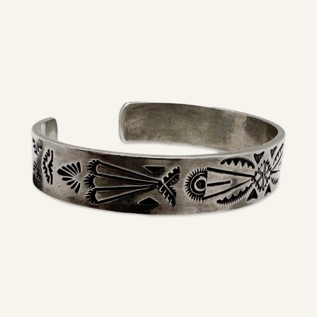 This is part of Chairish’s Costume Jewelry assortment. Hopi sterling silver cuff bracelet by Lucian Koinva. This Hopi cuff...
