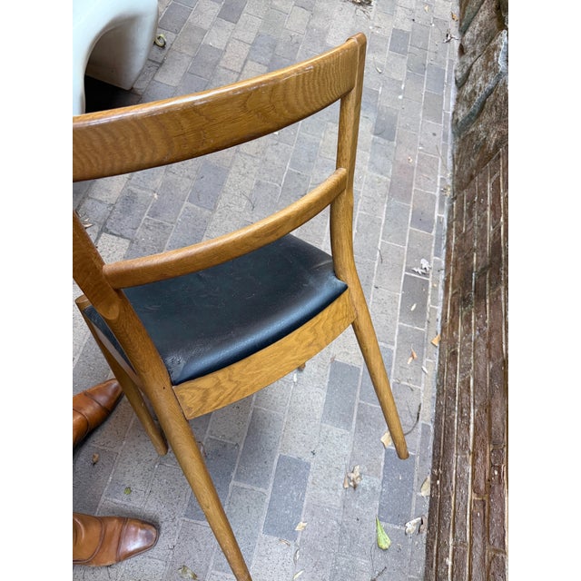 This mid-century Danish modern–style dining chair features a beautifully crafted solid wood frame with clean, sculptural...