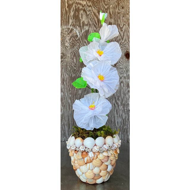 Contemporary hand-rolled paper flowers are a modern, artistic take on traditional floral arrangements. These flowers are...