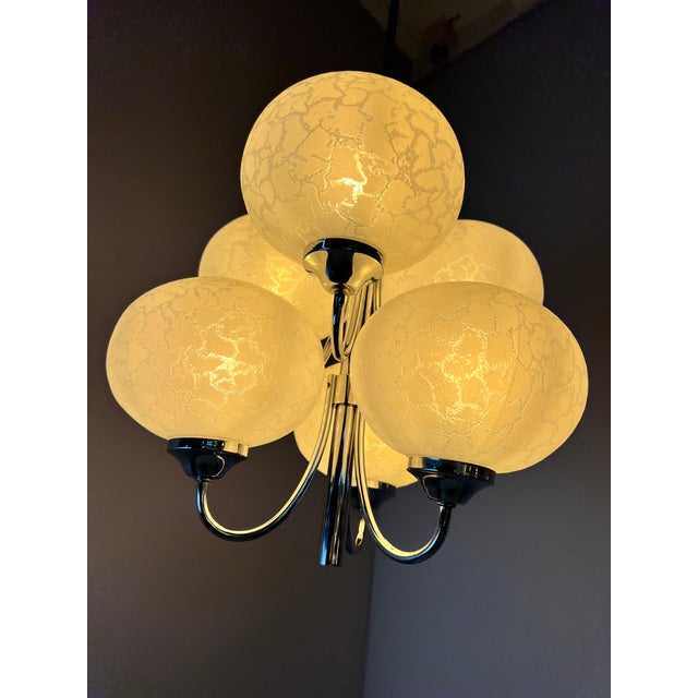 This six-light chandelier is the most compact version in Richard Essig's series for Hustadt, without sacrificing any...