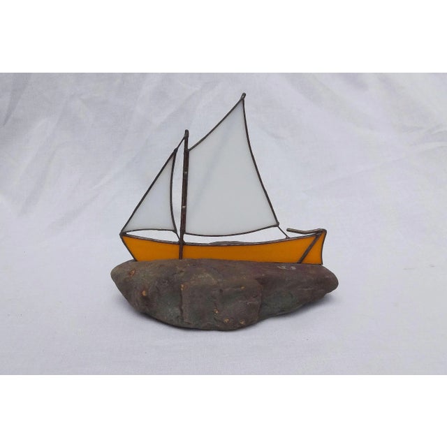 Glass and Rock. A colorful stained-glass sailboat set into a natural rock. The sailboat measures 7 x 5 5/8 inches. On...