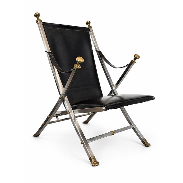 Striking neoclassical campaign-style folding chairs crafted in a refined combination of steel and solid brass with black...