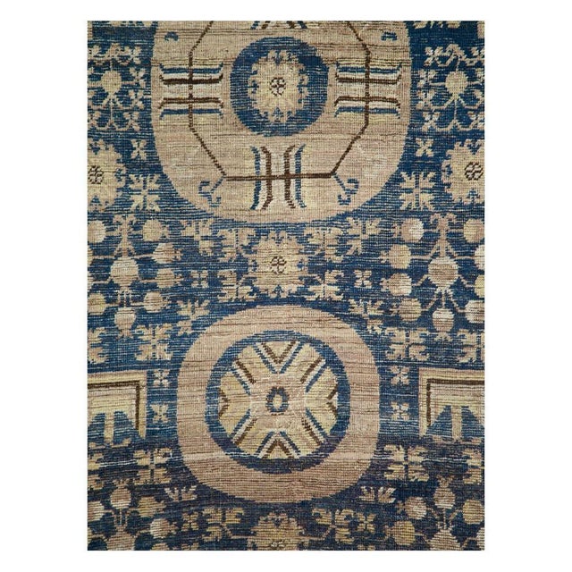 An antique East Turkestan Khotan gallery carpet handmade during the late 19th century. Measures: 6' 7" x 11' 4".