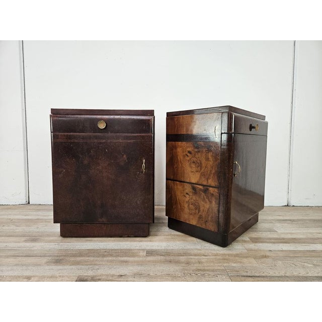 Pair of early 1950s bedside tables, entirely clad in oak burl, with a drawer and door with internal compartment. Suitable...