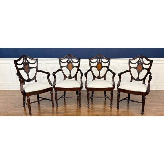 This is a set of four Inlaid Shieldback Arm Chairs by Leighton Hall. The feature shield backs with an inlaid medallion in...
